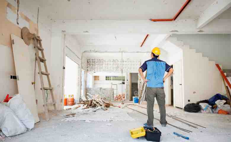 Construction worker in unfinished room.