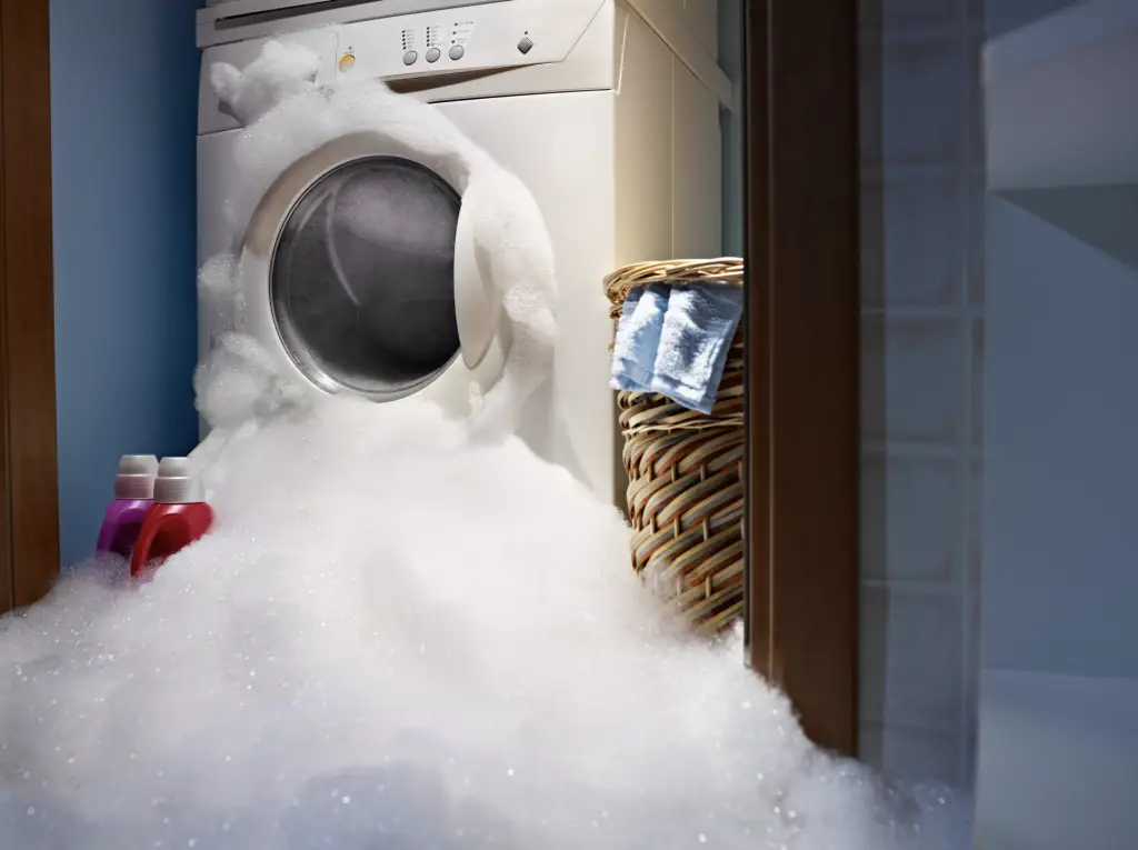 Washing machine overflowing with bubbles
