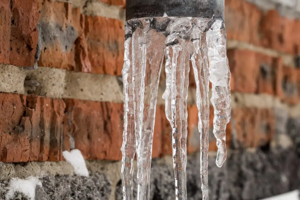Icicles hanging from a metal pipe